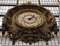 The clock hanging over the entryway to the museum. The building used to be a train station.