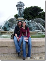 Kim and I posing together in front of a fountain.