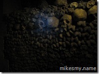 A wall of skulls and bones in the pale light of our LED lamps.